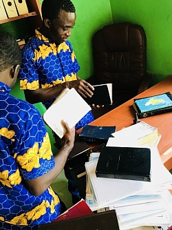 The brothers are adding mark of identification to the donated Bibles